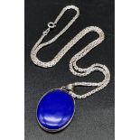 Lapis Lazuli oval shaped pendant set in solid silver along with an 18" silver chain. Both