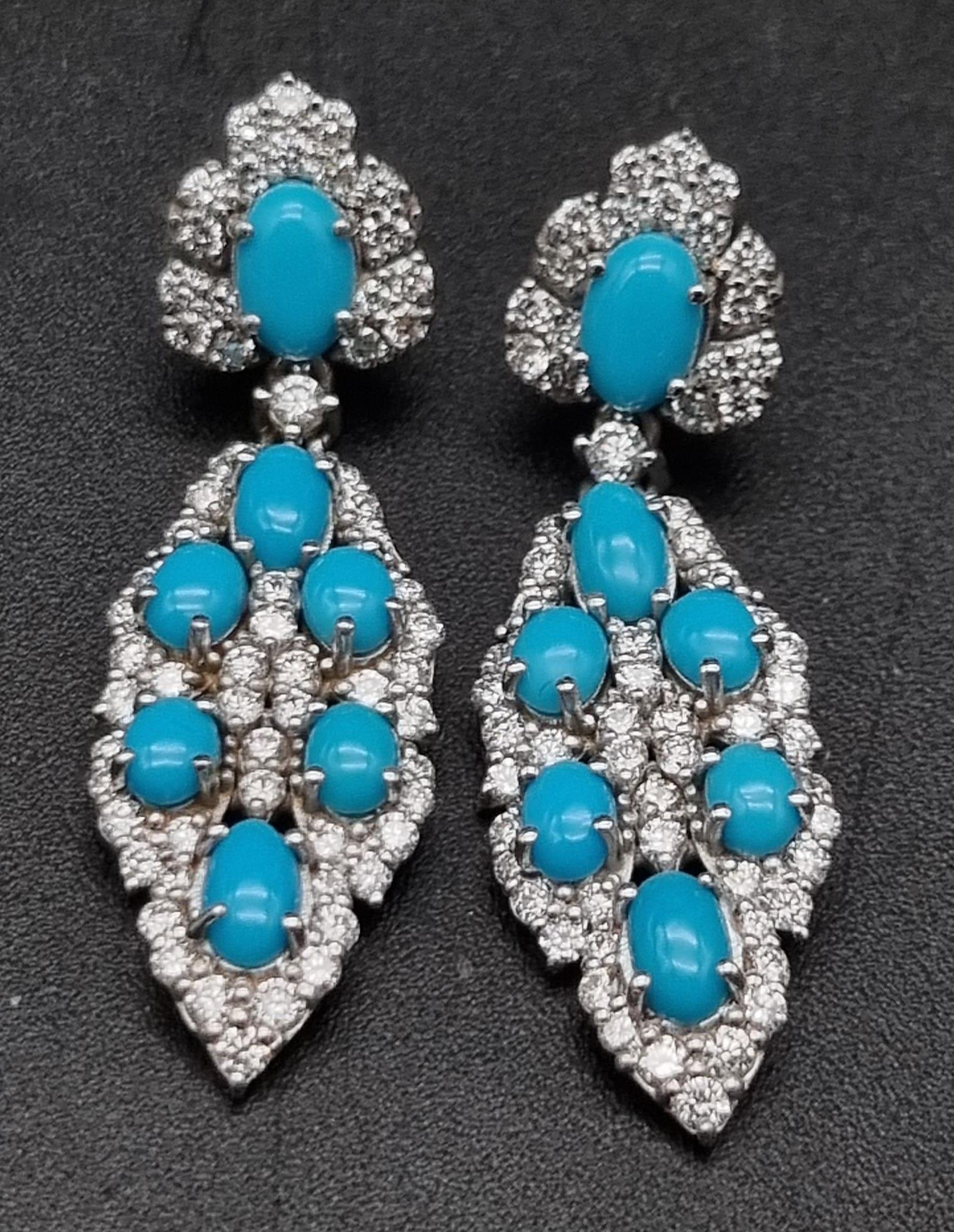 A Pair of Vintage 18K White Gold Diamond and Turquoise Earrings. A turquoise cabochon surrounded