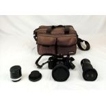 A Canon 35mm A-1 Camera with Extra Lenses - Comes in a carry case. A/F