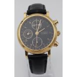 A BUCHERER AUTOMTIC CHRONOGRAPH IN 18K GOLD ON A TASTEFUL BLACK LEATHER STRAP WITH BLACK DIAL WITH