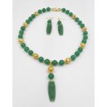 A Chinese, green jade necklace and earrings set with pendant cicadas. Necklace length: 47 cm,