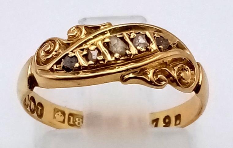 An Antique 18K Yellow Gold Diamond Ring. Five small graduating diamonds in-between scroll