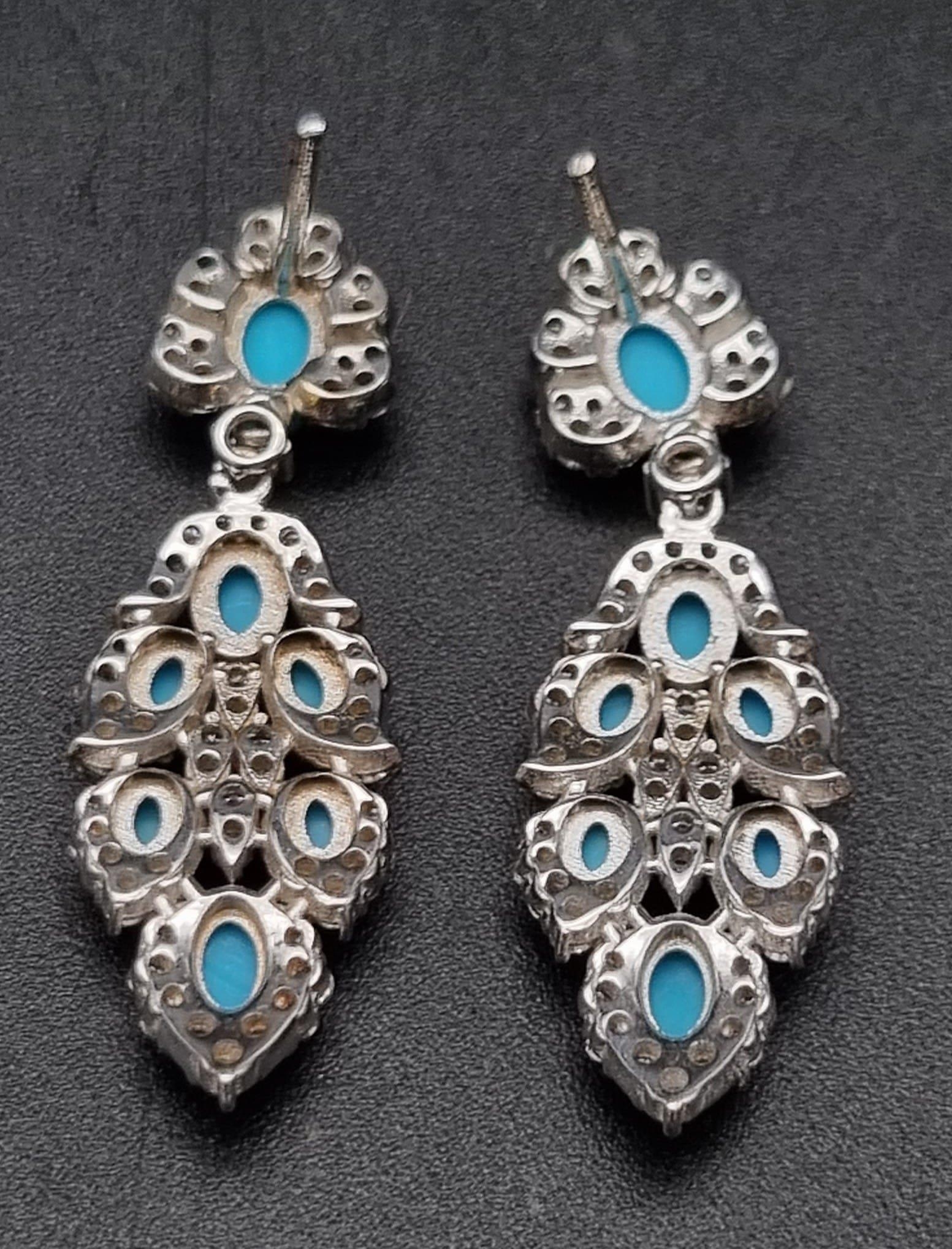 A Pair of Vintage 18K White Gold Diamond and Turquoise Earrings. A turquoise cabochon surrounded - Image 2 of 3