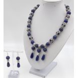 An unusual, Tibetan silver and lapis lazuli, Buddhist, necklace and earrings set. Necklace length: