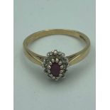 9 carat GOLD, RUBY RING , having oval cut RUBY set to top with WHITE TOPAZ Surround. Full UK