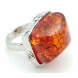 A Red-Coloured Resin Ring on White Metal. Size O. Resin - 2.5 x 2cm.