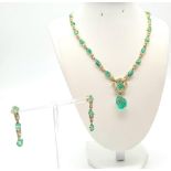 An 18K Yellow Gold Emerald and Diamond Necklace and Earring Set - 22 natural carved emeralds and 149