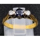 A Vintage 18K Yellow Gold Sapphire and Diamond Ring. Central sapphire with a diamond either side.