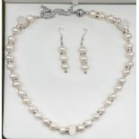 A high quality, Chinese, large pearl necklace with a dragon clasp accompanied by matching
