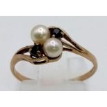 A Vintage 9K Yellow Gold Seed Pearl and Sapphire Crossover Ring. Size L. 1.22g total weight.