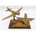 A Vintage 50 Year Commemorative Brass and Wood Parachute Regiment Desk Stand with Brass Aircraft,