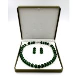A stylish emerald and cubic zirconia necklace and earrings set in a presentation box. Necklace