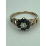 9 carat GOLD SAPPHIRE and TOPAZ RING flanked with gold open work Design shoulders. 1.9 grams. Size L