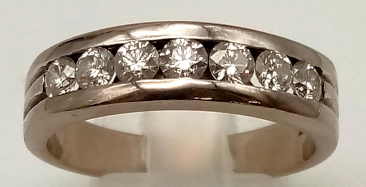 An 18K White Gold (tested) Seven Diamond Channel Gents Dress Ring. 1.5ct bright diamonds. Size U 1/