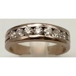 An 18K White Gold (tested) Seven Diamond Channel Gents Dress Ring. 1.5ct bright diamonds. Size U 1/