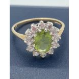 9 carat GOLD PERIDOT RING with zirconia surround. 2.0 grams. Size M.