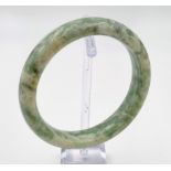 A vintage, Chinese, lime green and white jade bangle. Inner diameter: 63 mm. In original