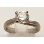 An 18 K white gold solitaire ring with a very attractive brilliant cut diamond (app. 0.9 carats).