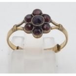 A Vintage 9K Yellow Gold Garnet Ring. Seven garnets creating the perfect flower. Size N. 1.3g