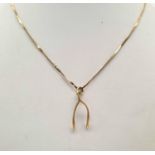 A 9K Yellow Gold Wishbone Pendant on a 9K Yellow Gold Necklace. 3.28g total weight/