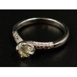 An 18K White Gold Diamond Ring. Champagne centre stone with diamonds on shoulders. 0.30ct. Size M.