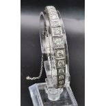A platinum tennis bracelet with large brilliant cut diamonds. Length: 18 cm, weight: 31.67 g.
