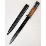 Spanish M1943 Mauser K98 bayonet with scabbard. Makers mark 'PR8' on cross-guard. Wooden grips. In