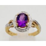 A 9K Yellow Gold Ring with a Centre Amethyst and Halo Diamonds surrounded by and on both shoulder.