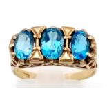 A 9K Yellow Gold Blue Turquoise Ring. Three clean turquoise stones set in a pierced foundation. Size