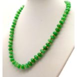 An Emerald Bead Necklace with Gilded Spacers and Clasp. 44cm.