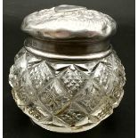 An Antique Small Crystal Glass Pill Bottle with Sterling Silver Top. The top is embossed and out