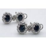 An 18 K white gold pair of earrings with diamonds and blue/green sapphires. Length: 25 mm, total