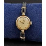 A Vintage 9K Yellow Gold Ladies Omega Watch. 9K yellow Gold part-strap and case - 20mm. Gold dial.