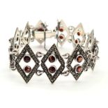 STERLING SILVER FANCY GARNET SET BRACELET. 27G. 16CM