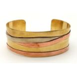 A Wonder Woman-esque Three-Colour Open-Ended Gilded Bangle.