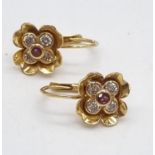 A Pair of 18K Yellow Gold Diamond Earrings. 0.4ct of diamonds (VS2) set in the form of a flower with
