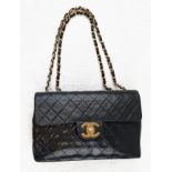 A Classic Jumbo Chanel Handbag. Black caviar leather in a diamond quilt formation. Interwoven