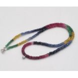 A Natural Emerald, Ruby, Sapphire Gold and Diamond Necklace. Colourful beads with a small diamond