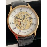 Gentlemans quartz SEKONDA SKELETON WRISTWATCH in gold tone,, having large face with black digits and