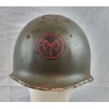 WW2 US M1 Swivel Bale Helmet Front Seam Helmet with insignia of the 27th Infantry Division.