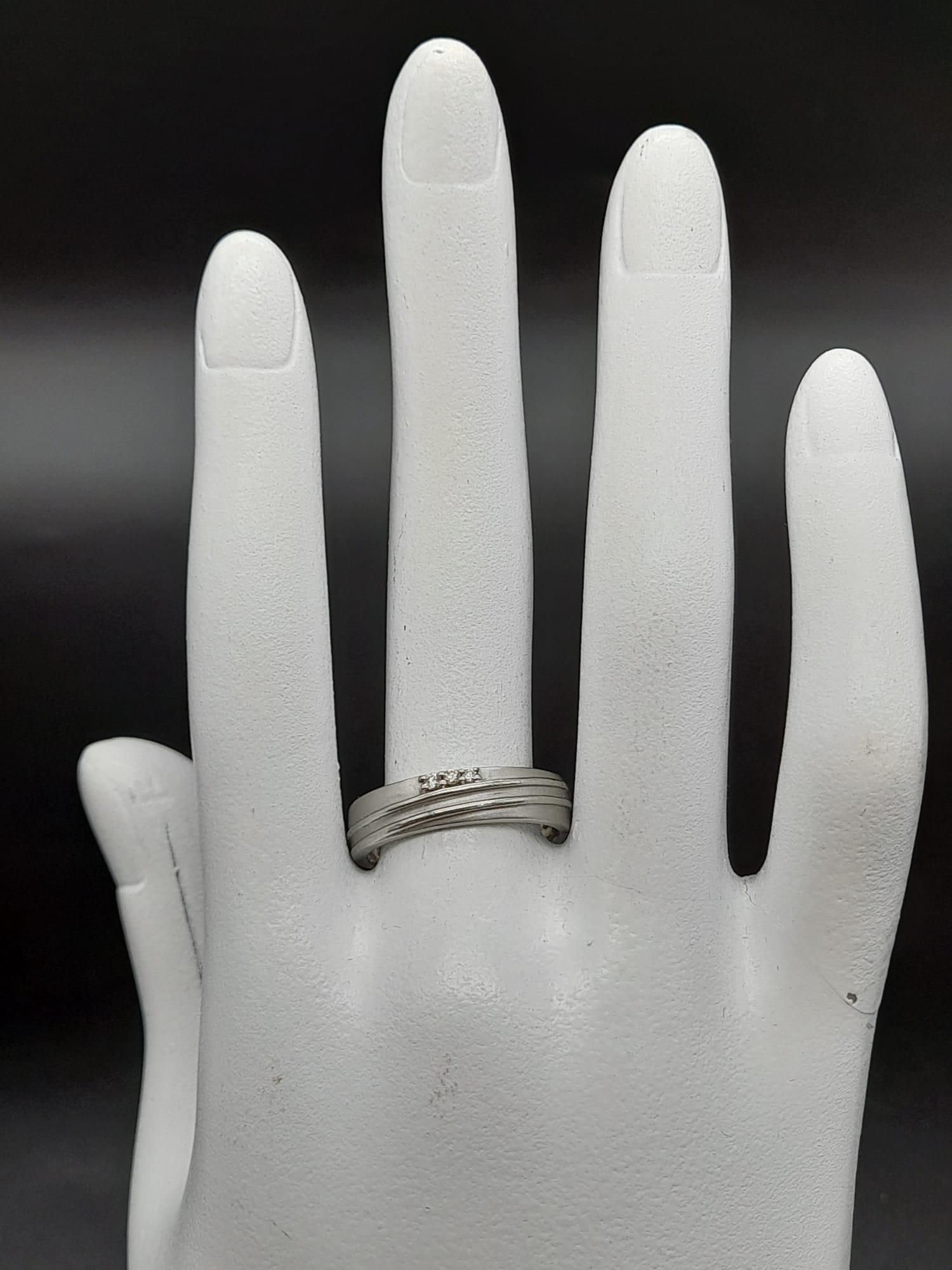 A 950 Platinum Diamond Band Ring. Three small diamonds. Size Q. 5.19g total weight. Ref - 190 - Image 11 of 12