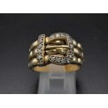 A 9K Yellow Gold and Diamond Buckle Ring. 18 diamonds .25ct complement this keeper piece. Size Q.