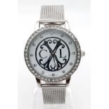 A CHRISTIAN LACROIX ladies watch. 36 mm dial, white face with the designer’s emblem, white metal