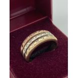9 carat GOLD and DIAMOND RING ,having three bands of different coloured gold set with diamonds and