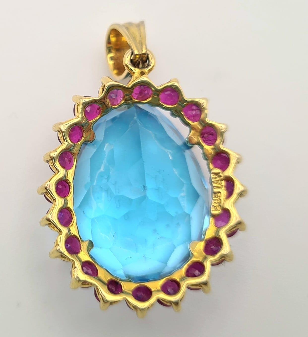 A 14K Yellow Gold Large Topaz and Ruby Pendant. 7.93g total weight. Large bright topaz surrounded by - Image 3 of 4