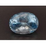 An oval cut faceted blue topaz (9.25 carats) with GLA certificate. Dimensions: 14.02 x 10.62 x 8.