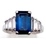A 14 K white gold ring with a beautiful emerald cut blue sapphire (3 carats) and baguette