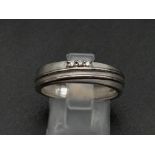 A 950 Platinum Diamond Band Ring. Three small diamonds. Size Q. 5.19g total weight. Ref - 190