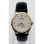 An Exquisite 1960s Longines 14K Gold Gents Watch. Black leather strap with 14K gold case - 33mm.