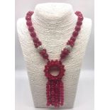 A Faceted Fuchia-Pink Chalcedony Statement Necklace. Graduated beads leading to a large circular